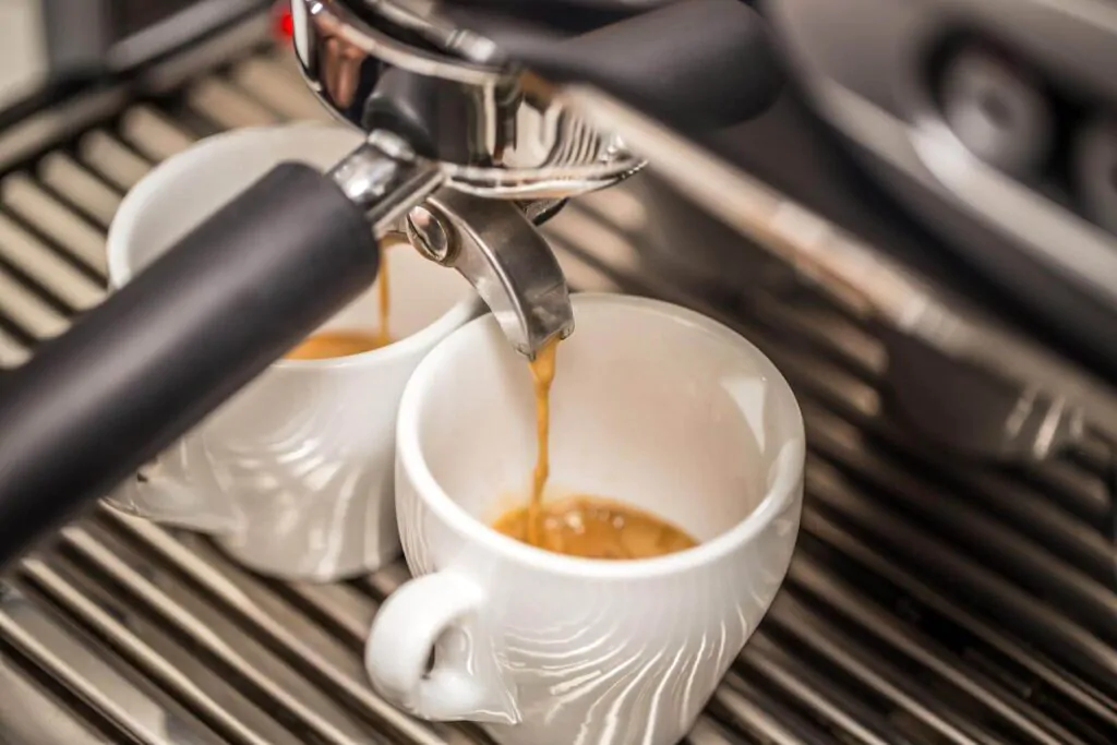 espresso machine pouring coffee to the two coffee cup