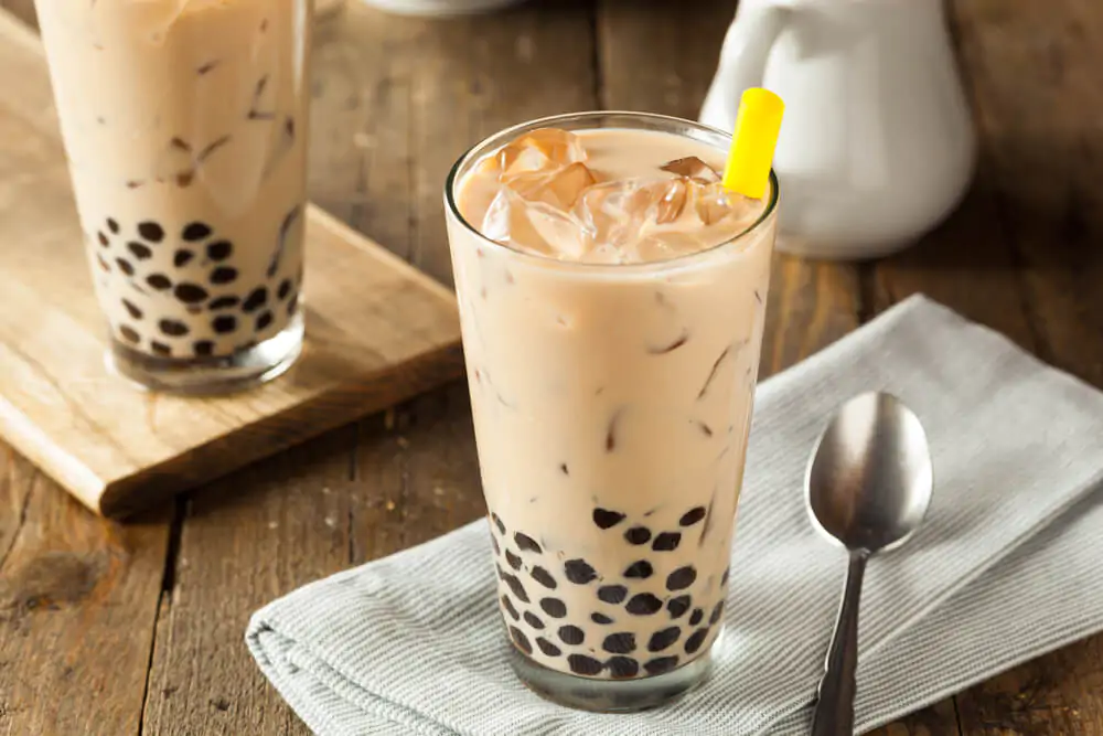 Back milk tea with brown sugar tapioca pearls in a wooden table