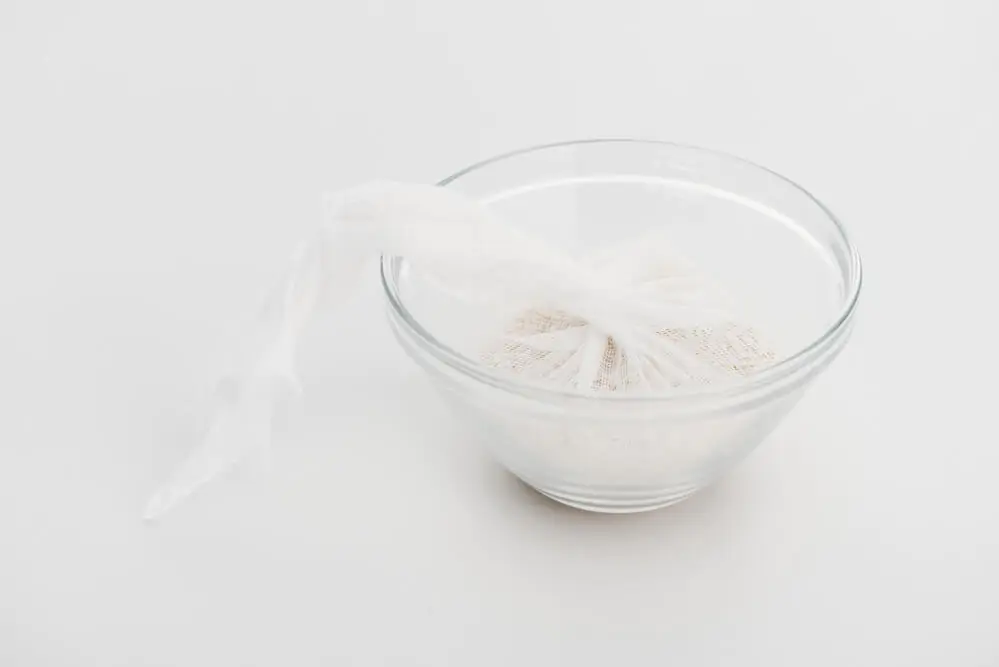 A cheesecloth in a small glass bowl