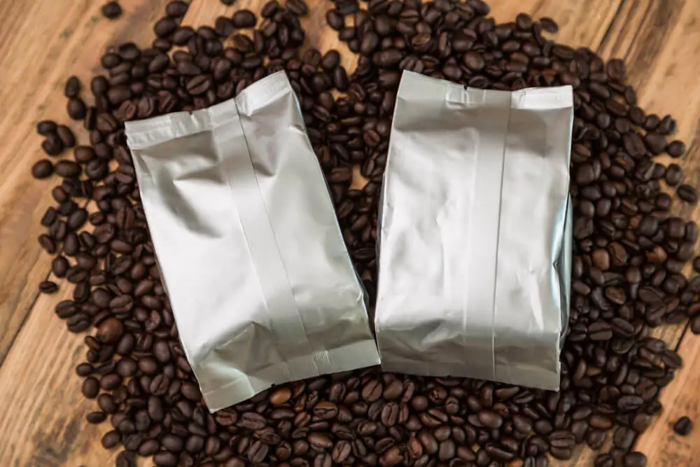 a foil bag lying on top of the coffee beans
