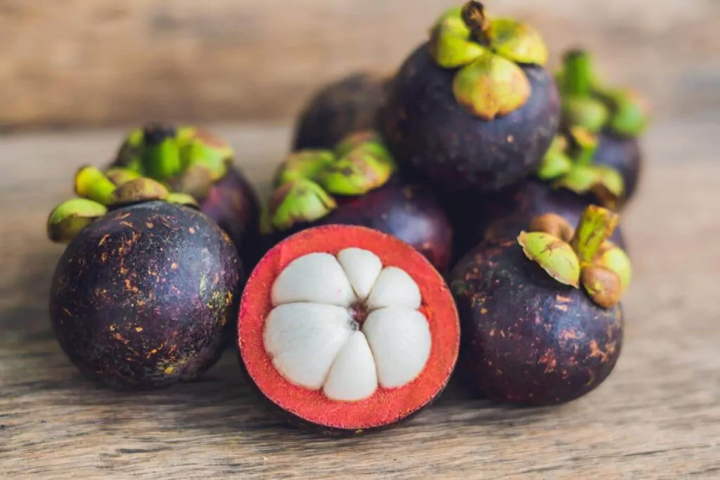 Mangosteen fruit on old wooden table