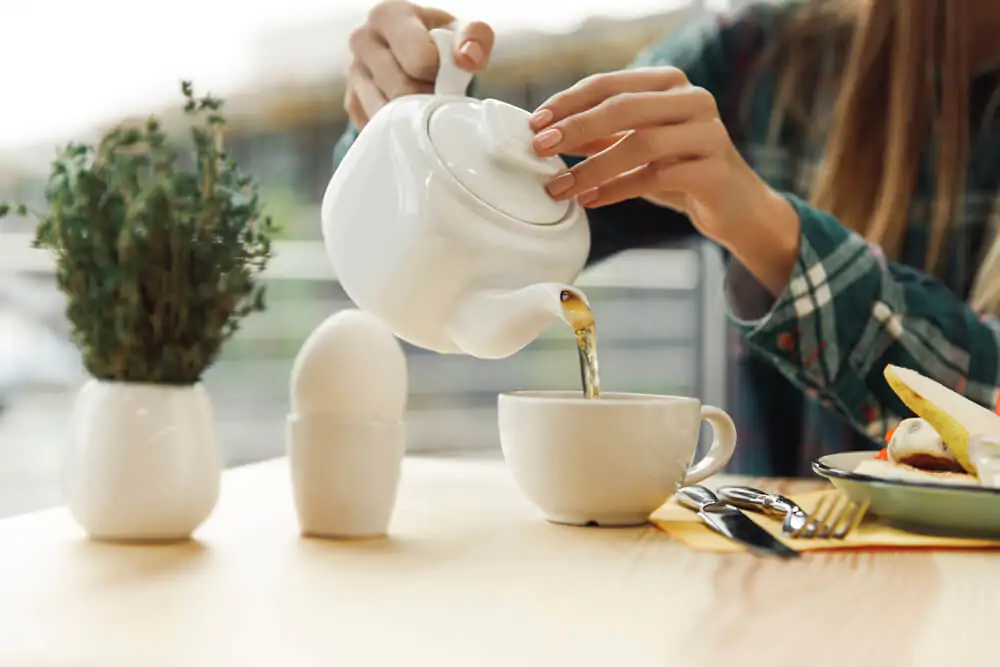 girl pouring tea from teapot