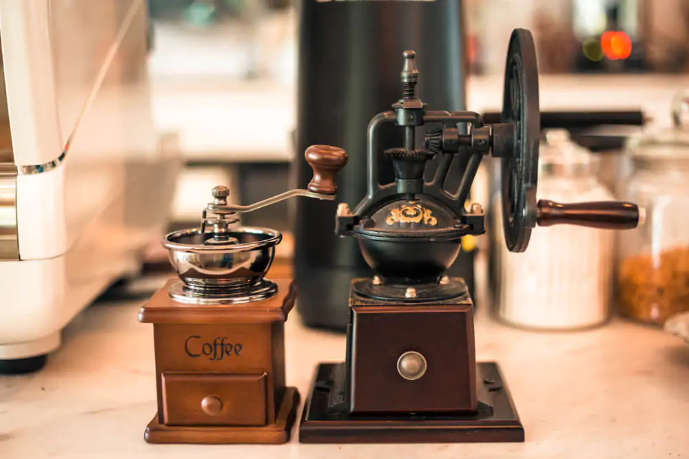 Manual coffee grinder on the table in coffee shop - best coffee grinders for percolator