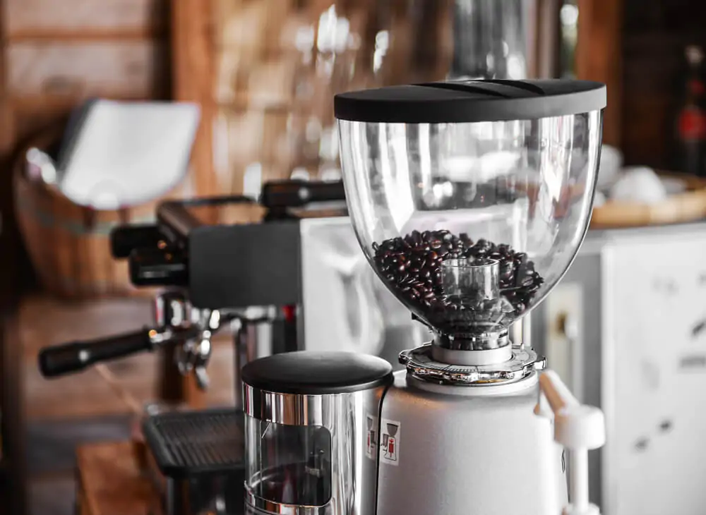 an electric coffee grinder with coffee beans inside it