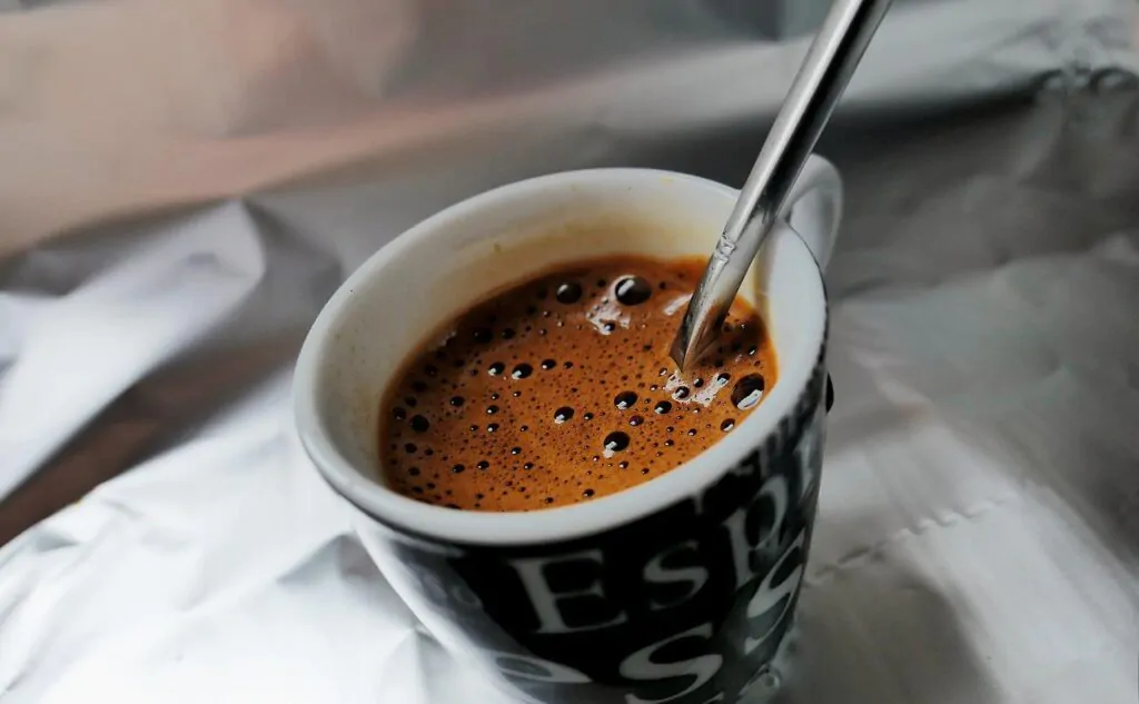 an espresso cup of coffee with spoon