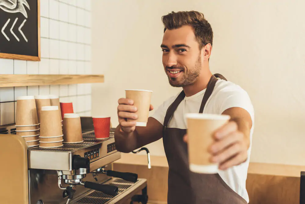 Barista showing coffee to go - New coffee business ideas