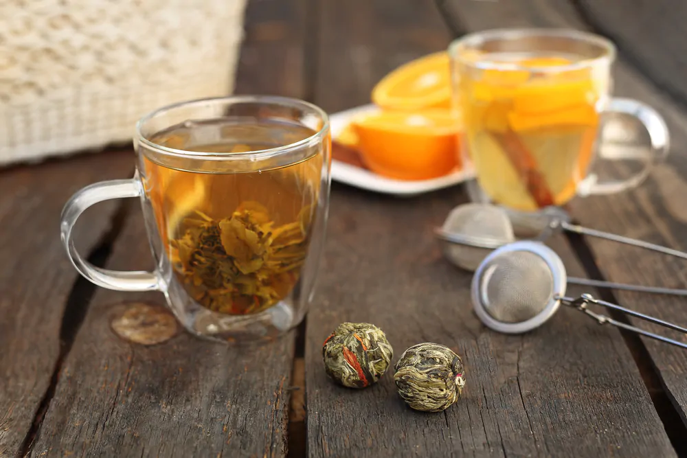 A green tea flower is brewed in a transparent glass - What is medicine ball tea
