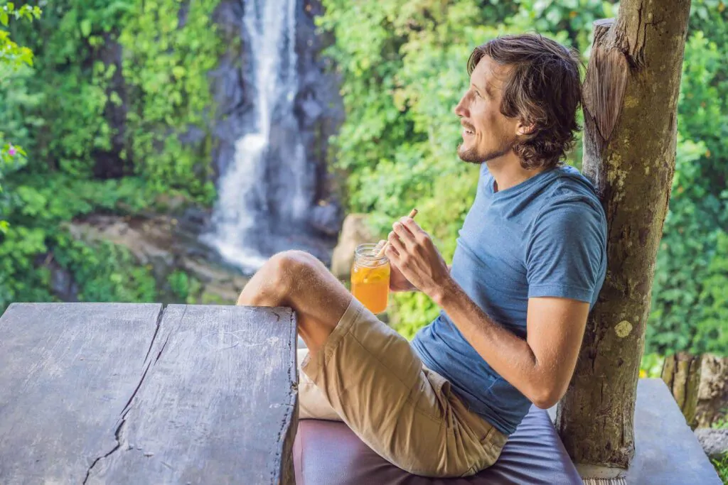 man drinking a fermented tea and feeling happy being with nature