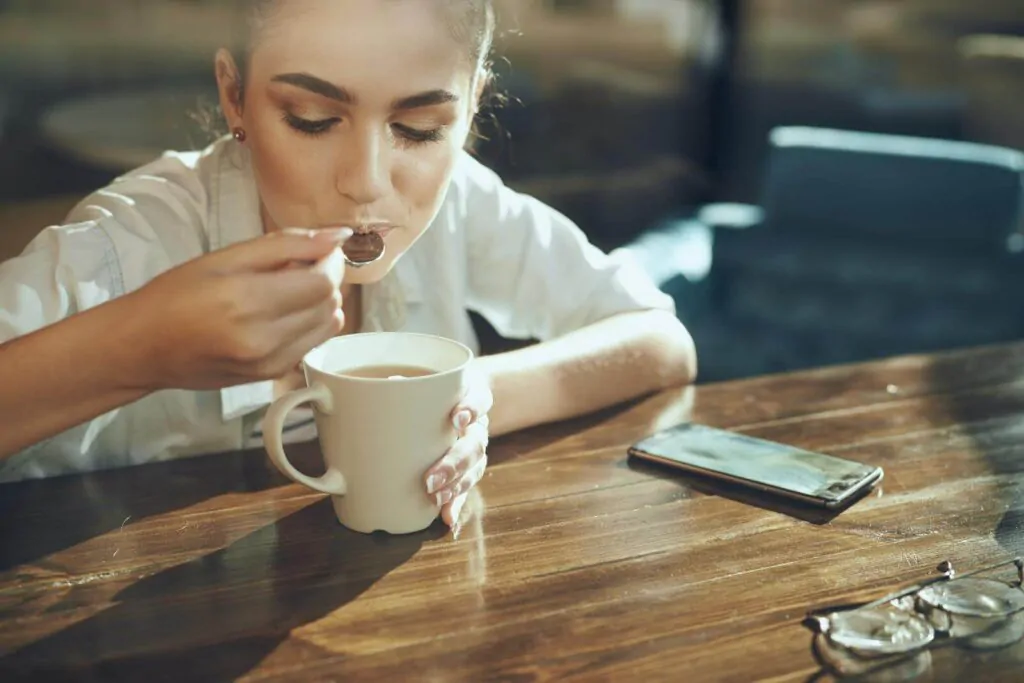 Business woman in a cafe drinking sweet coffee