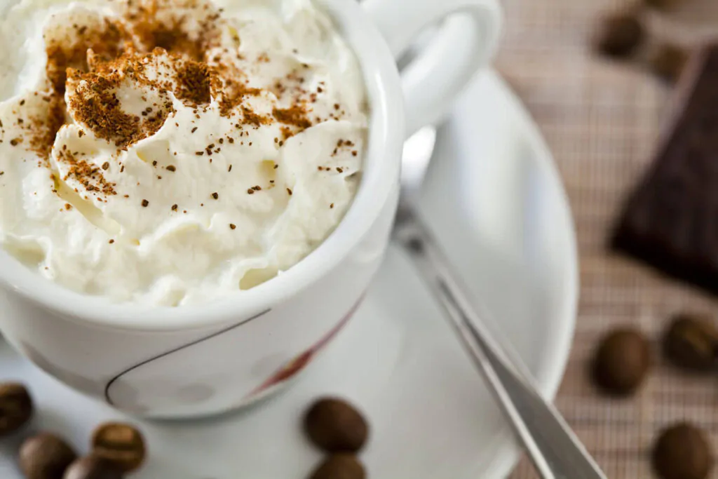 Close-up photograph of an espresso coffee with whipped cream