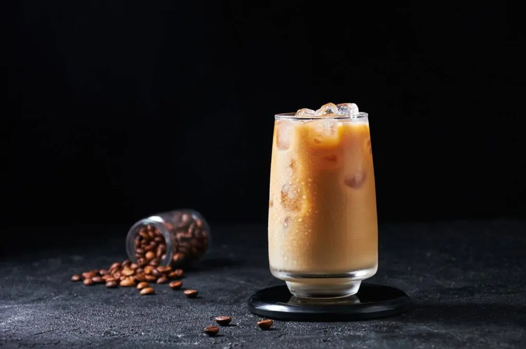 Iced Coffee with Milk in Tall Glass on Dark Background