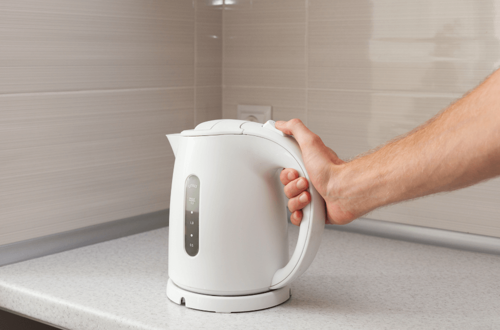 Man holding electric kettle