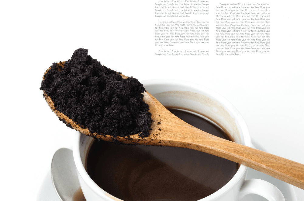 Used coffee grounds and  a cup of coffee