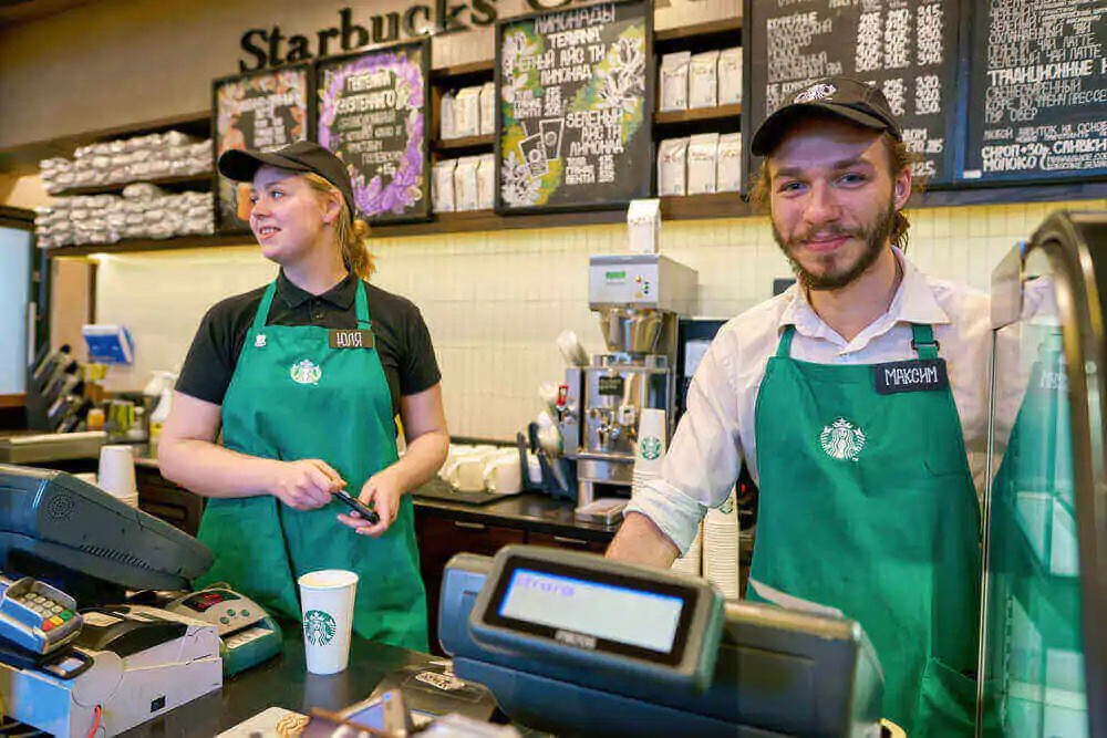 two Starbucks employees working cheerfully