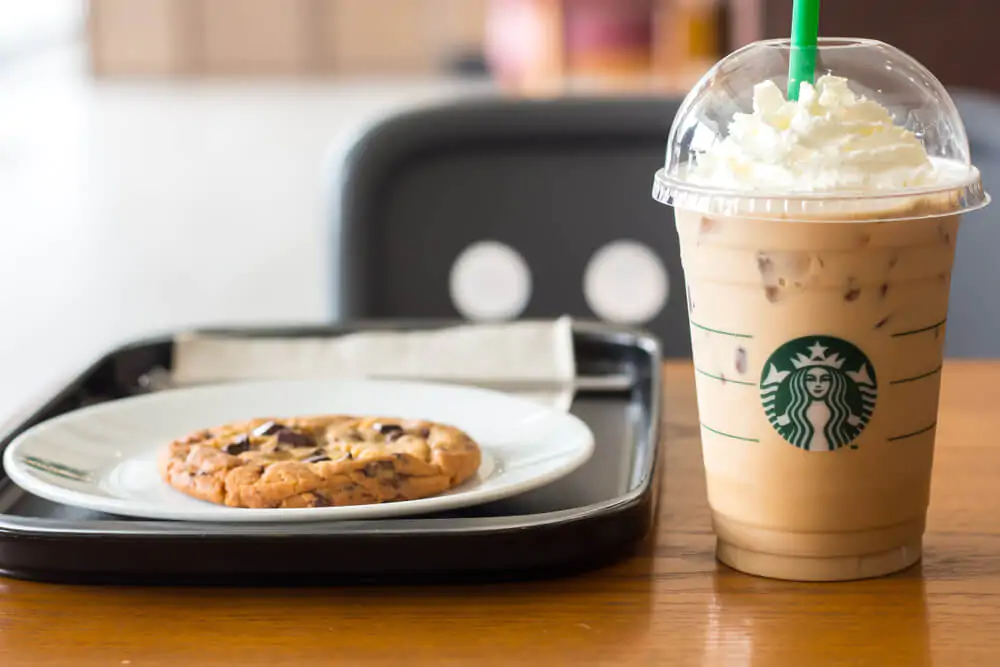 Starbucks White Chocolate Chip Mocha and Soft Chocolate Chip Cookie on wooden table