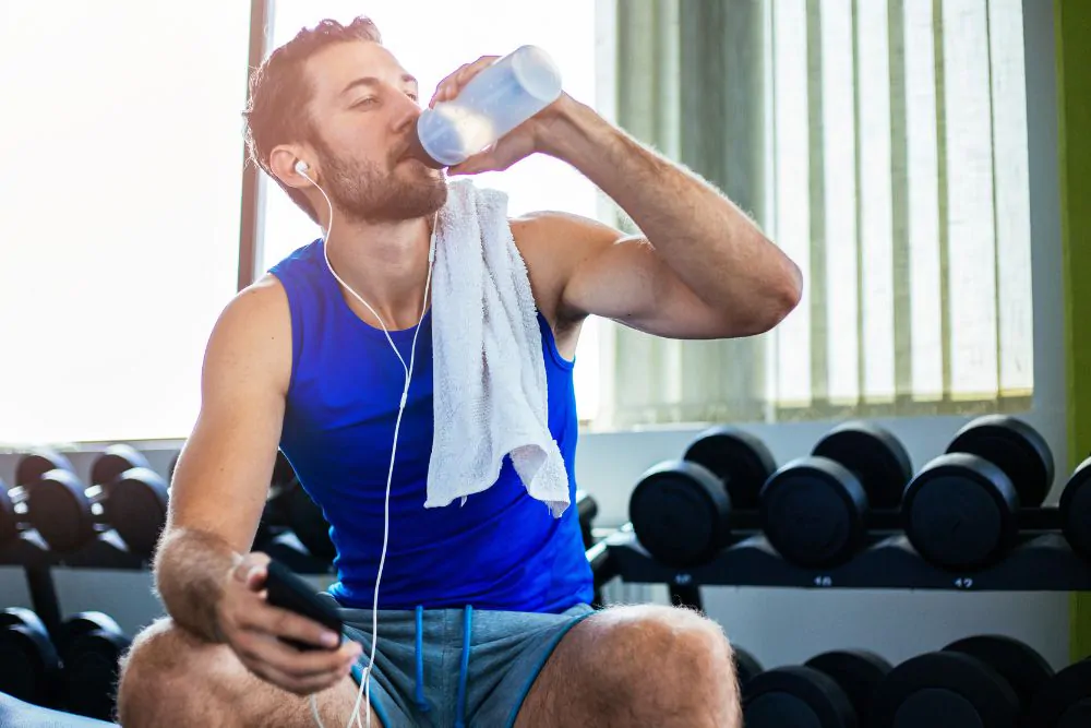 Athlete drinking water at the gym