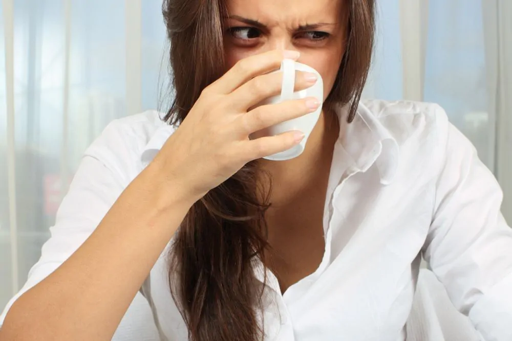 Woman tries tasteless coffee