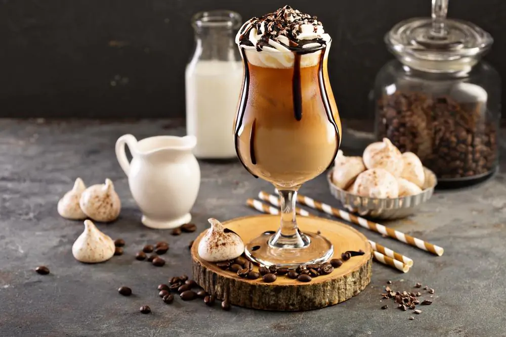 Ice coffee with cream on marble table