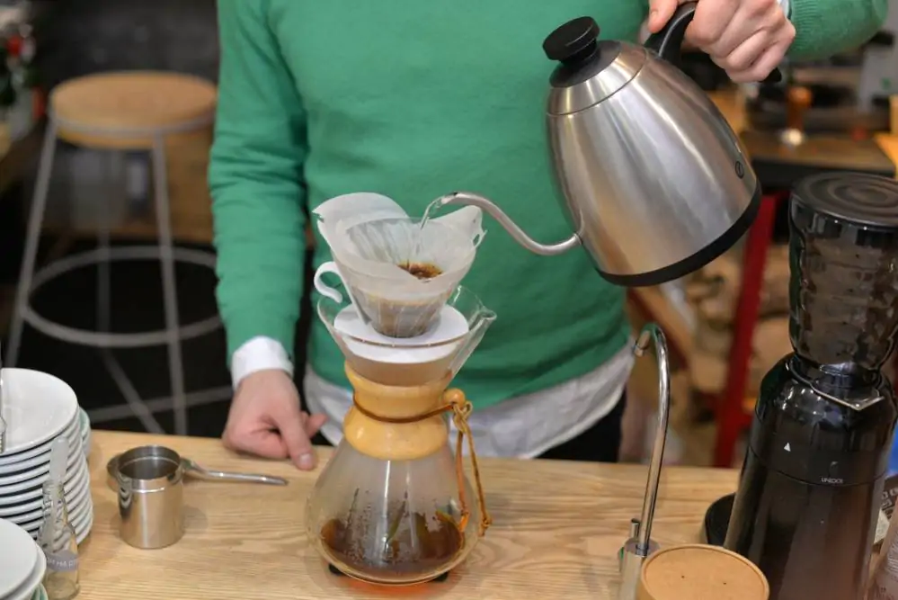 barista pouring coffee into a Chemex