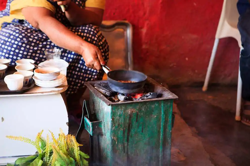 Woman preparing coffee for tourists in a traditional way