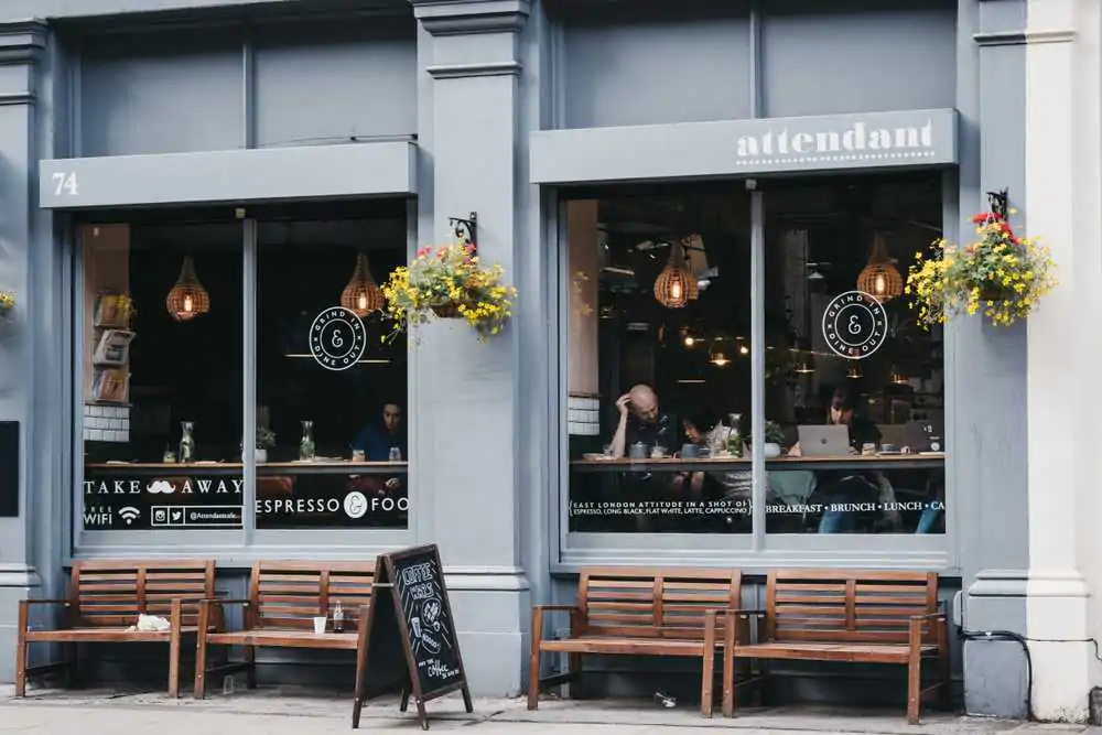 View through the window of people inside Attendant cafe and bar in Shoreditch, a trendy area of Londons East End that is home to an array of markets, bars and restaurants.